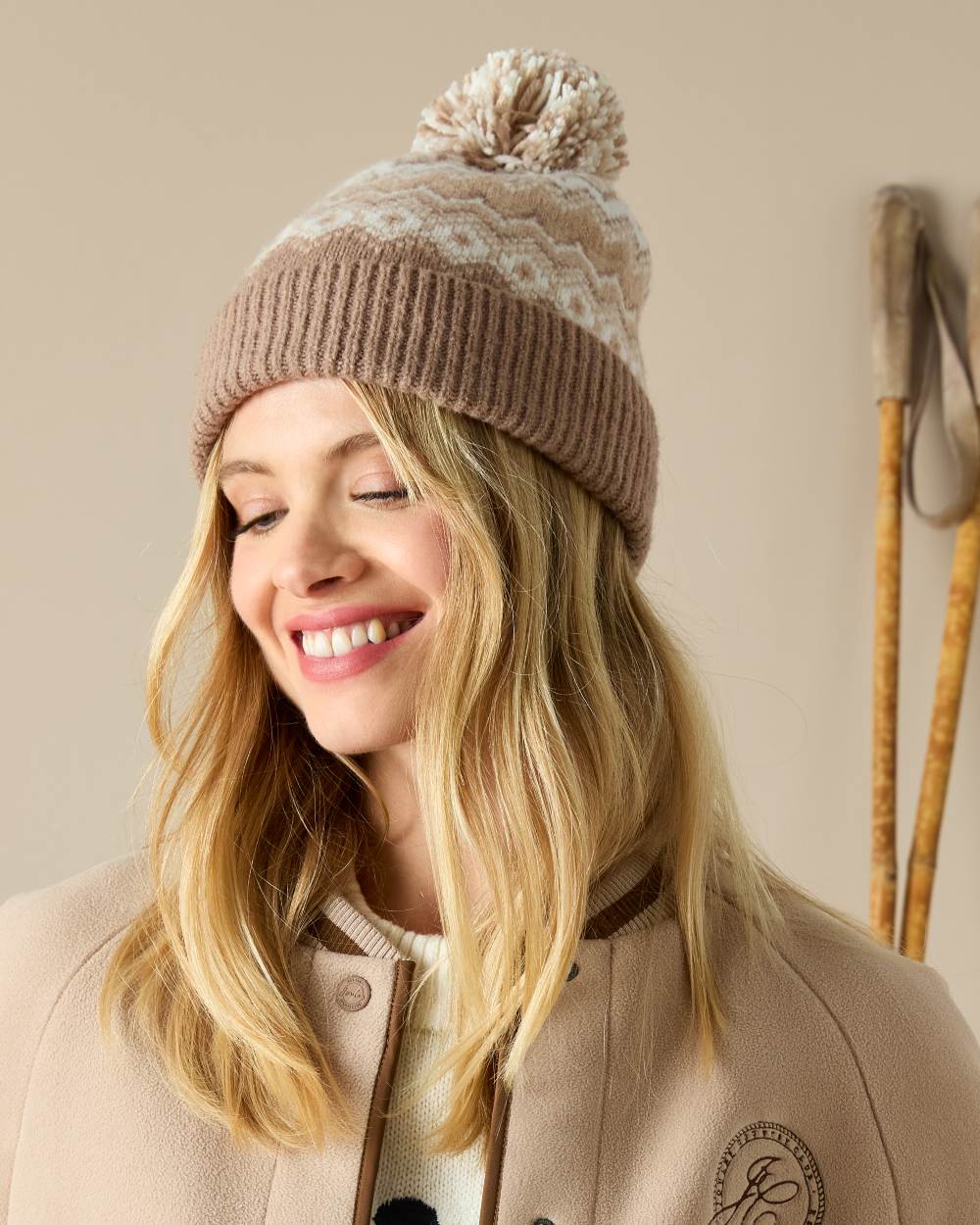 Neutral Coloured Joules Womens Kara Fairisle Bobble Hat on indoor background 