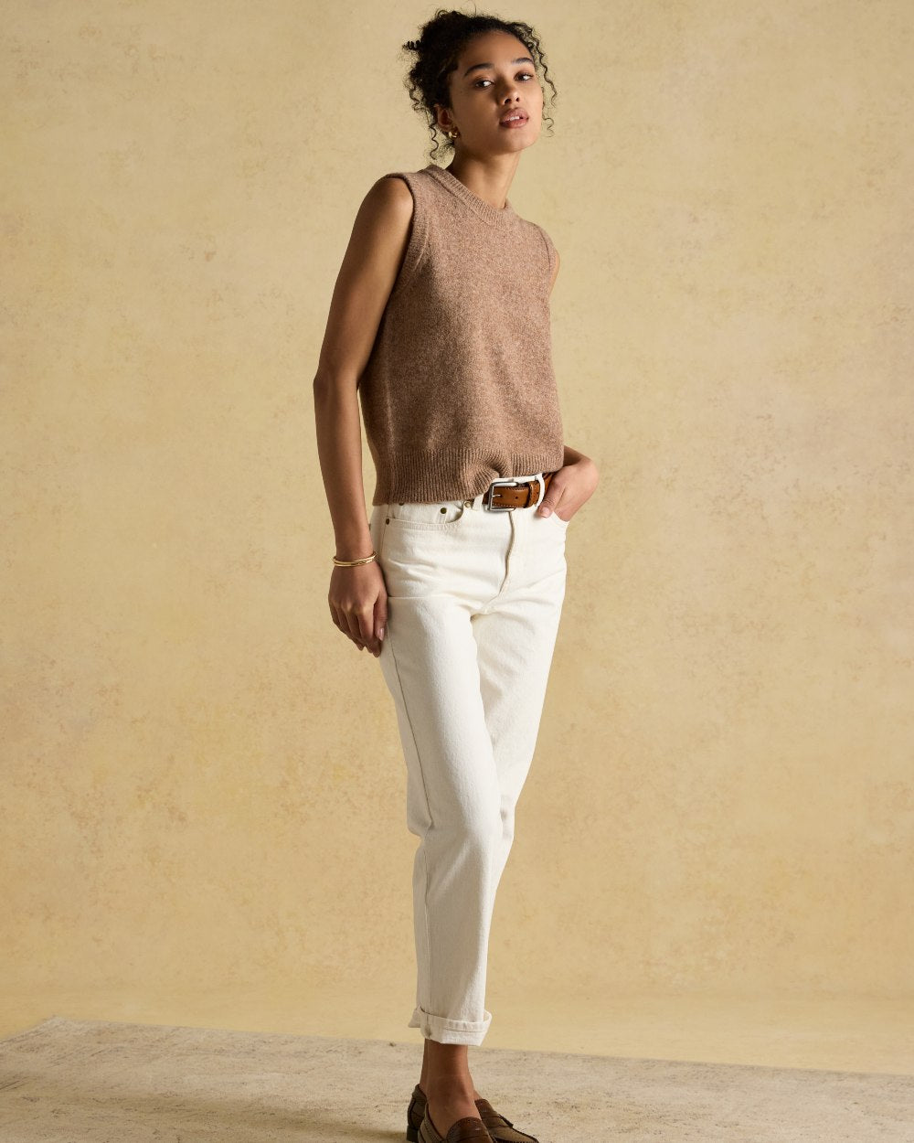 Tan coloured Joules Womens Holly Knitted Vest on wall background 