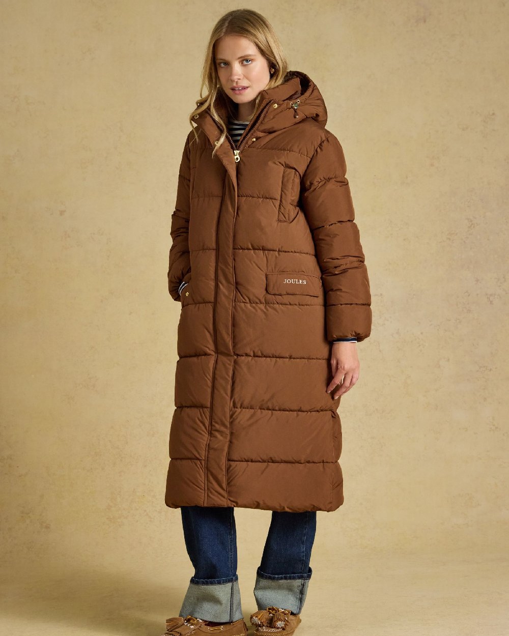 Brown Coloured Joules Womens Matchday Toffee Longline Showerproof Coat on Cream Background 