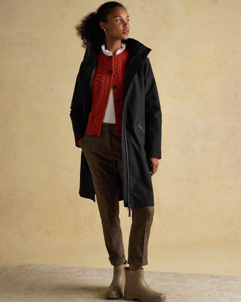 Black Coloured Joules Womens Rainaway Waterproof Longline Raincoat on indoor background 
