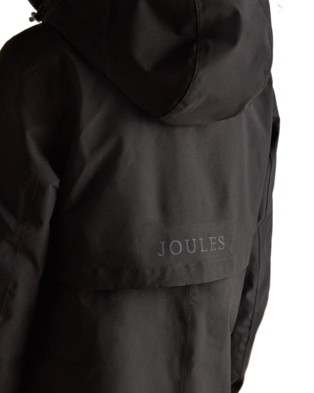 Black Coloured Joules Womens Rainaway Waterproof Longline Raincoat on white background 