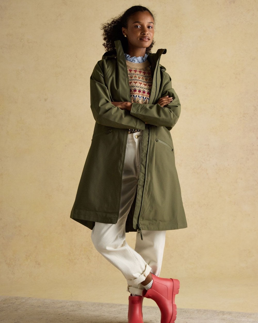 Green Grapeleaf Coloured Joules Womens Rainaway Waterproof Longline Raincoat on Indoor background 