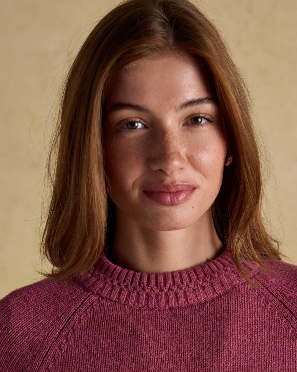 Pink coloured Joules Womens Rutland Intarsia Cotton Rich Knitted Jumper on wall background 