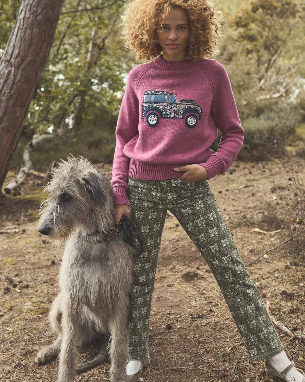 Pink coloured Joules Womens Rutland Intarsia Cotton Rich Knitted Jumper on forest background 