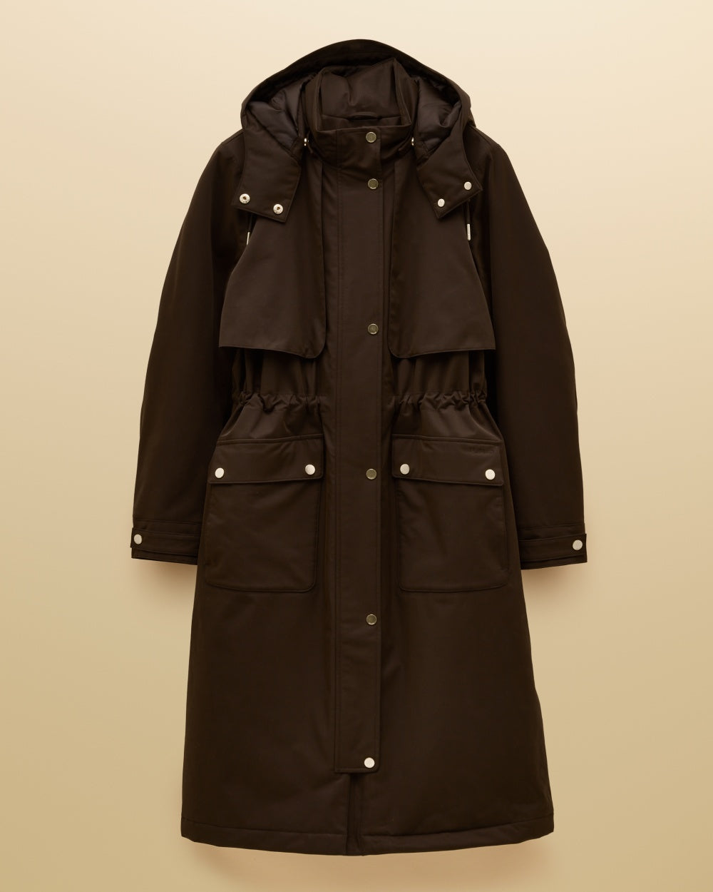 Chocolate Brown coloured Joules Womens Warmwell Waterproof Fleece Lined Raincoat on tan background 