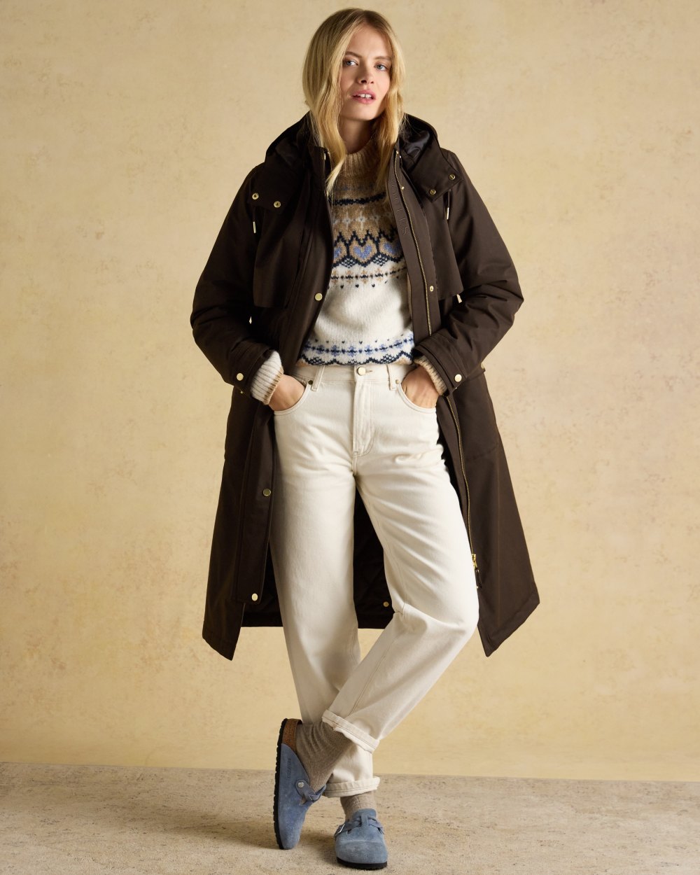 Chocolate Brown coloured Joules Womens Warmwell Waterproof Fleece Lined Raincoat on tan background 