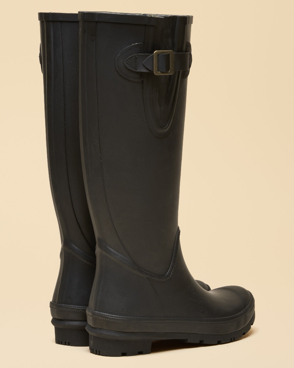 Black coloured Joules Womens Houghton Adjustable Tall Wellies on tan background 