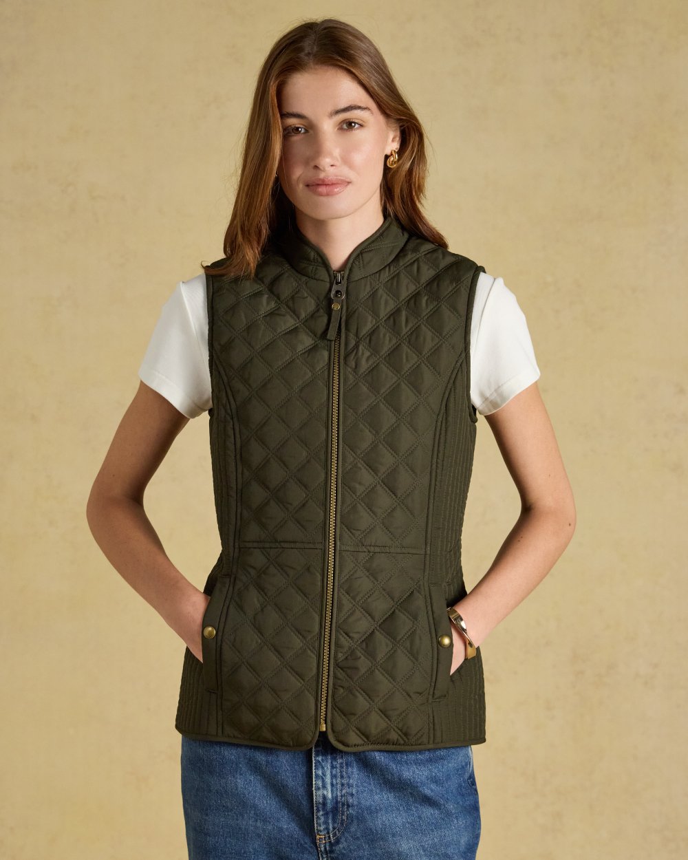 Green coloured Joules Womens Minx Showerproof Diamond Quilted Gilet on a gold background 