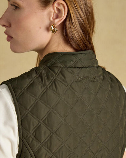 Green coloured Joules Womens Minx Showerproof Diamond Quilted Gilet on a gold background 