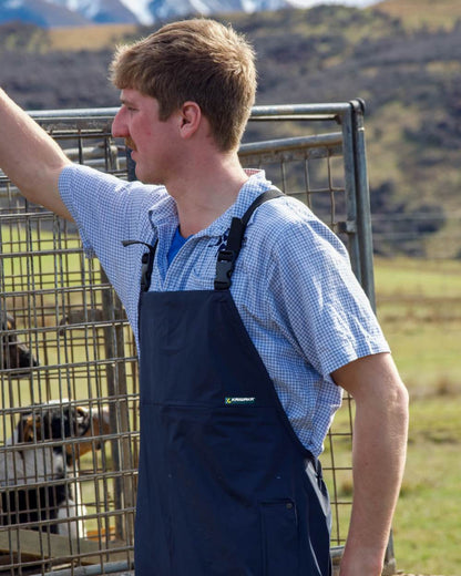 Navy coloured Kaiwaka Mens Agtex Bib Overtrousers on mountain background 