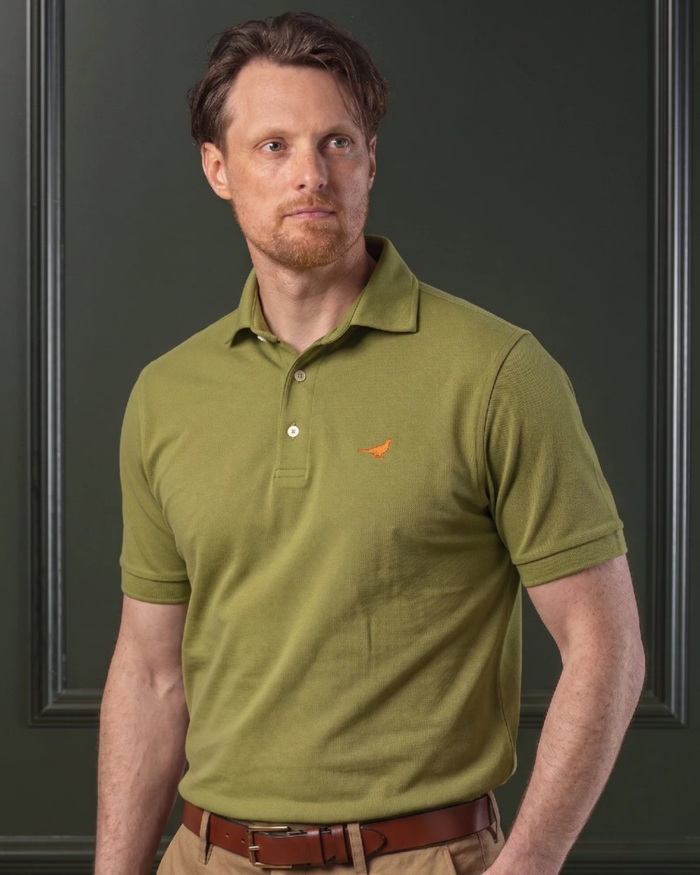 Olive coloured Laksen Mens Amalfi Polo T-Shirt on wall background 