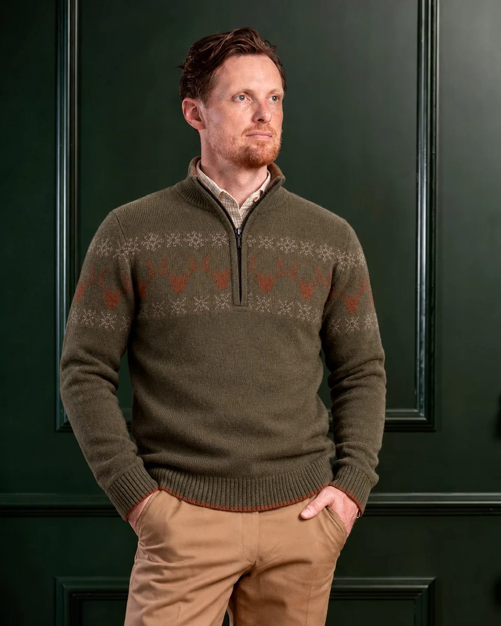 Green Coloured Laksen Mens Deer Jacquard Lambswool Sweater on Wall Panel Background 