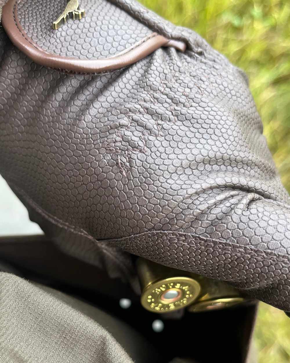 Olive coloured Laksen Mens Ultra Grip Shooting Gloves on forest background 