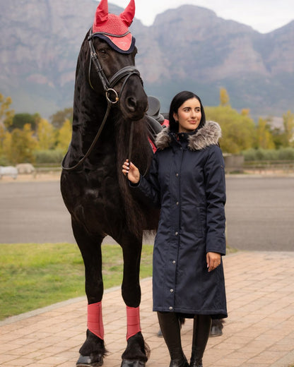 Navy Coloured LeMieux Anya Waterproof Riding Coat On A Mountain Background 