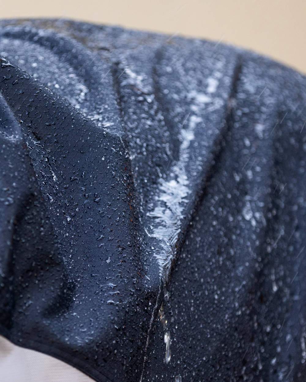 Navy coloured LeMieux Arika Shower Tek Fly Rug on blurry background 