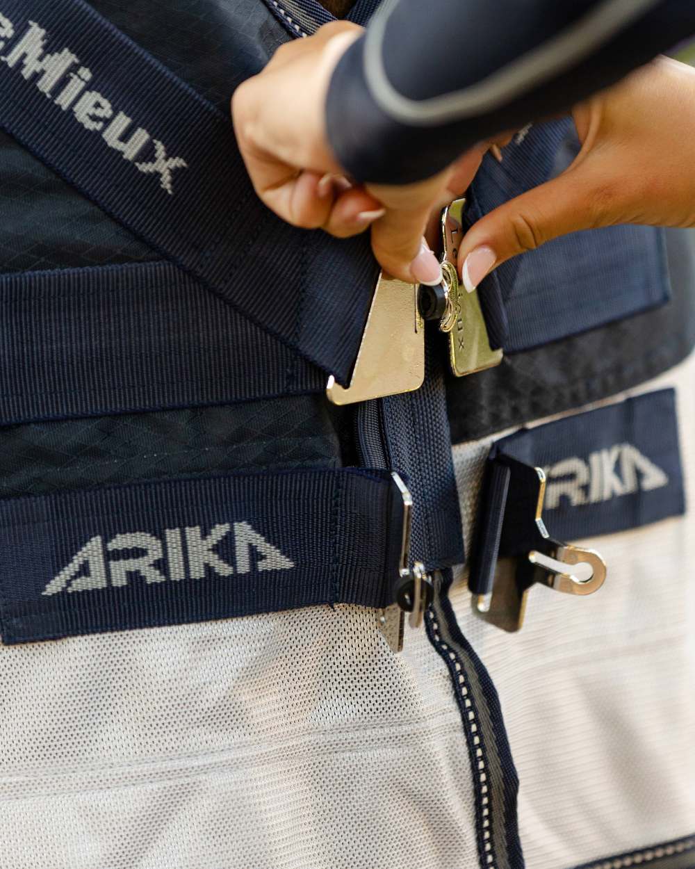 Navy coloured LeMieux Arika Shower Tek Fly Rug on blurry background 