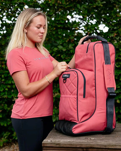 Cranberry coloured LeMieux Boot &amp; Hat Bag on tree background 