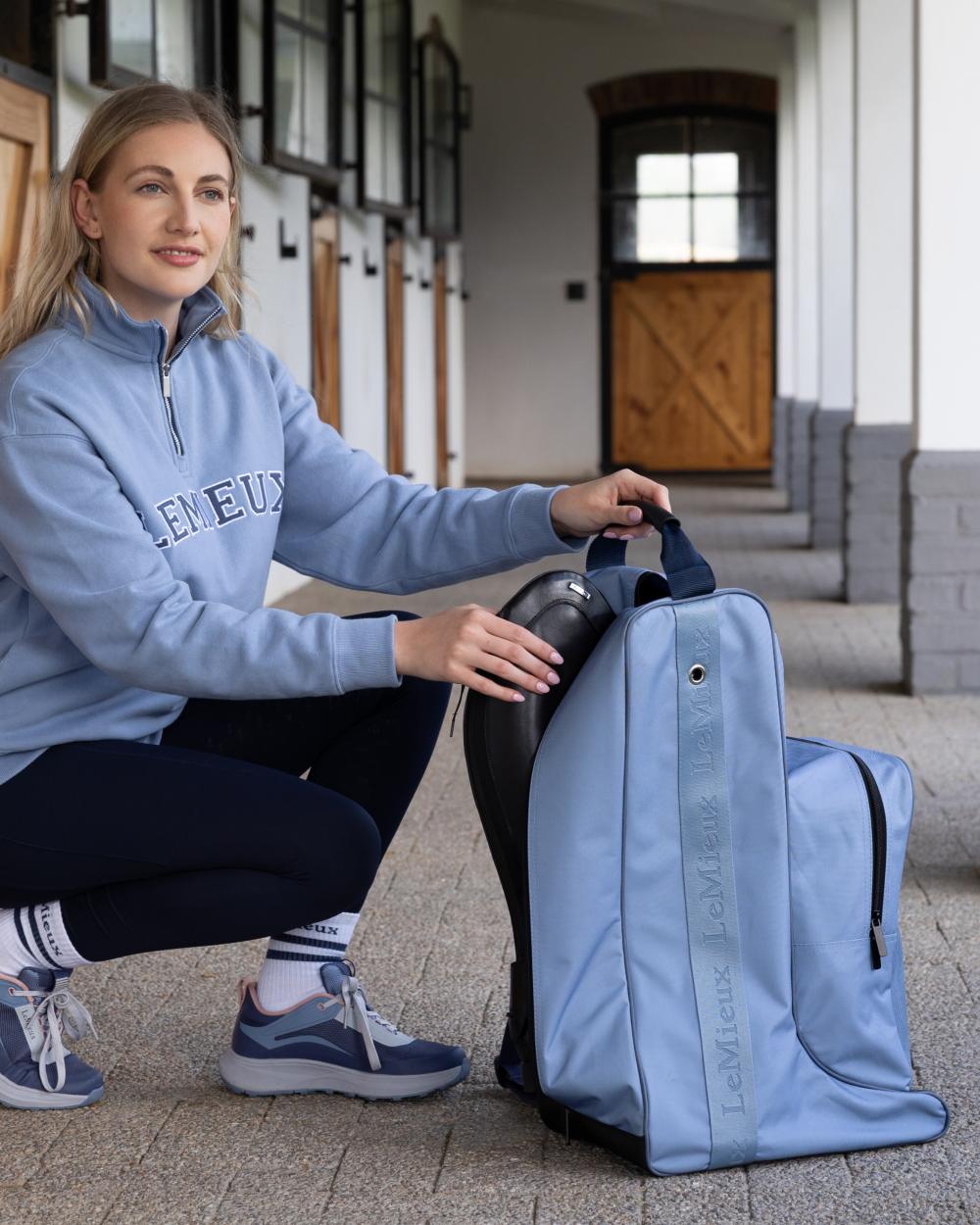 Powder Blue coloured LeMieux Boot &amp; Hat Bag on outdoor background 
