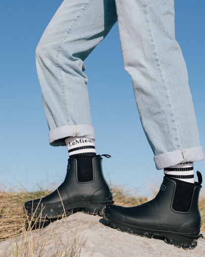 Black coloured LeMieux Bramshaw Chelsea Wellies on rock background 
