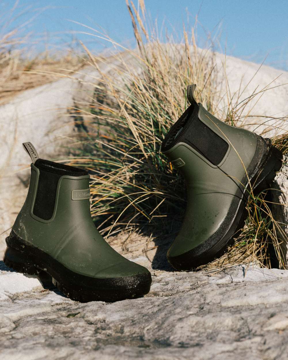 Olive coloured LeMieux Bramshaw Chelsea Wellies on rock background 
