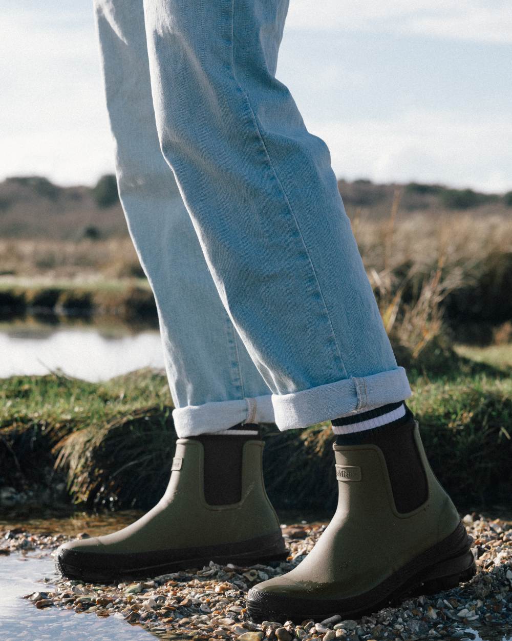 Olive coloured LeMieux Bramshaw Chelsea Wellies on soil background 