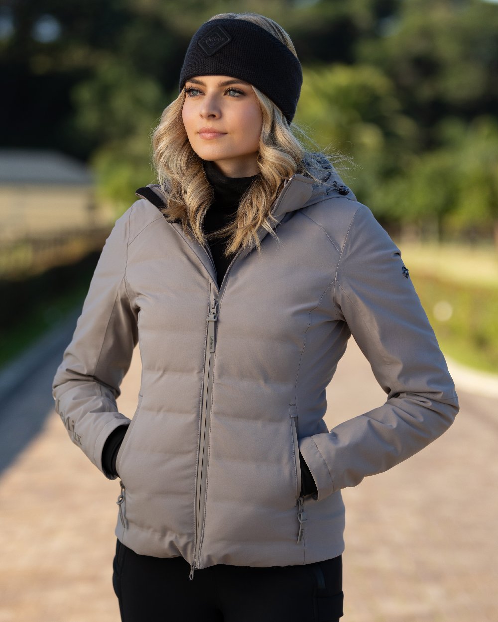 Ash coloured LeMieux Brooke Waterproof Hybrid Jacket on blurry background 