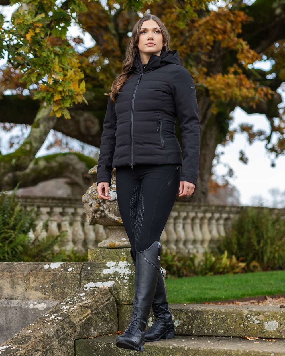 Black coloured LeMieux Brooke Waterproof Hybrid Jacket on park background 