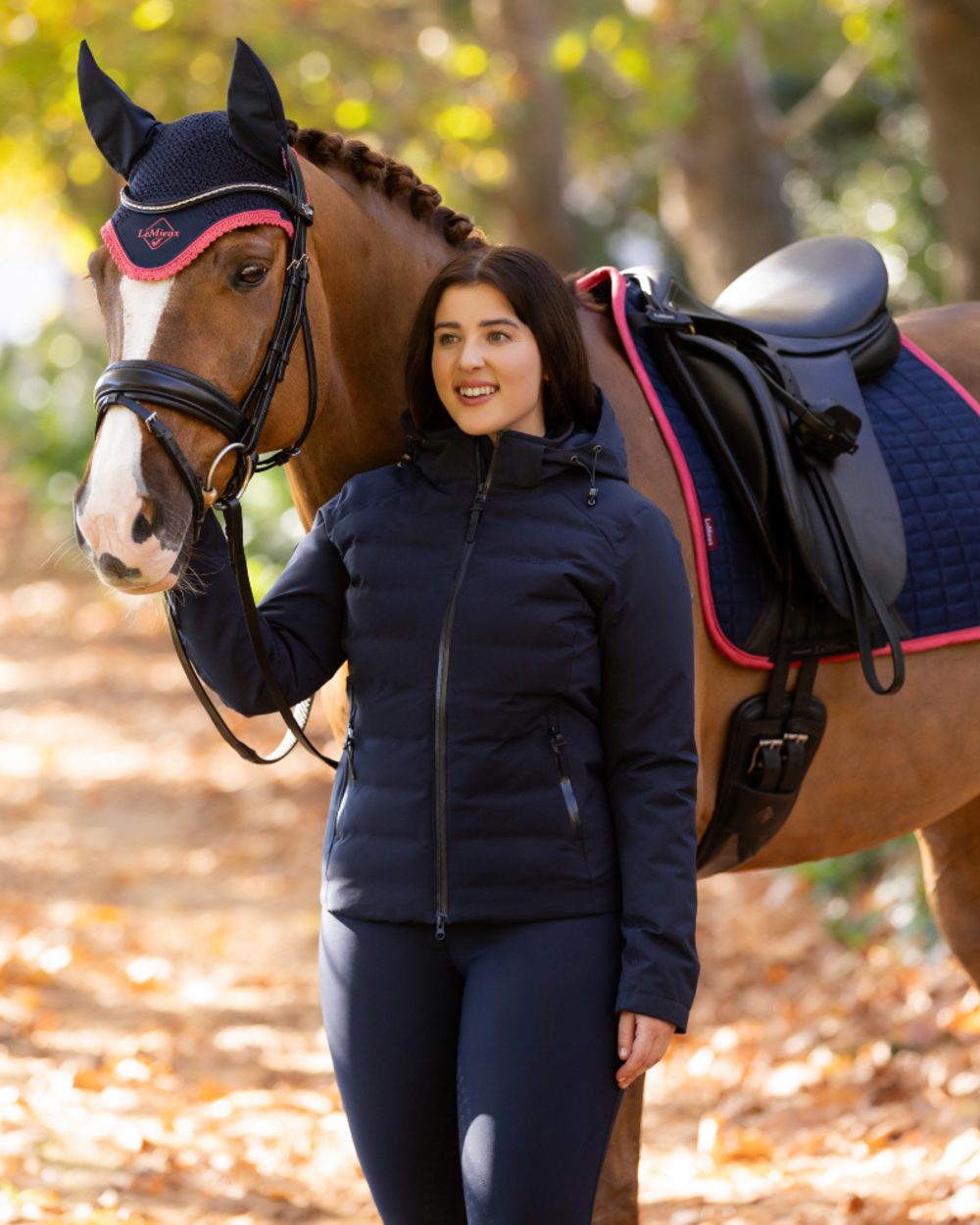Navy coloured LeMieux Brooke Waterproof Hybrid Jacket on tree background 