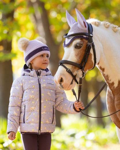 Lilac coloured LeMieux Childrens Mini Printed Lilo Puffer Jacket on tree background 