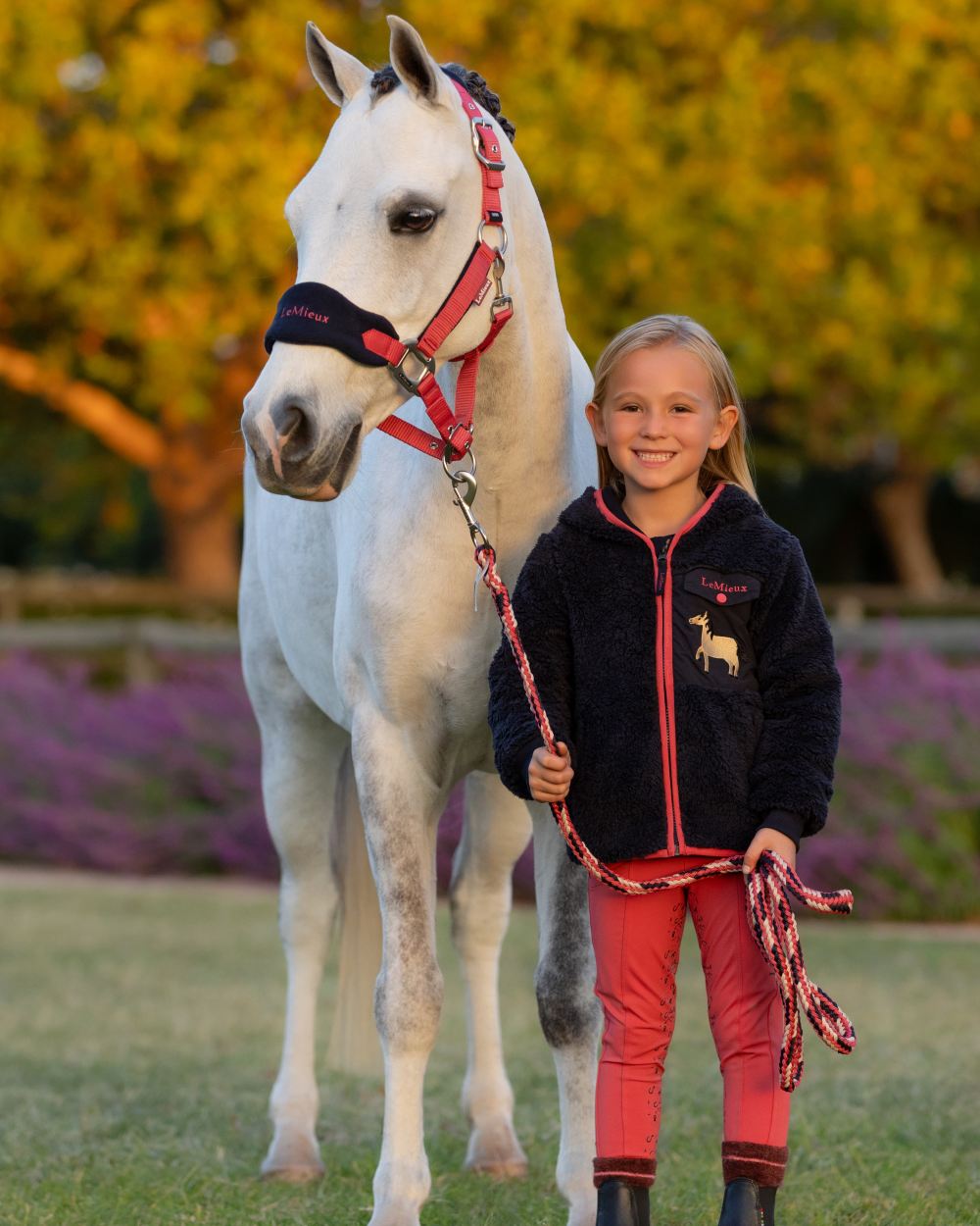 Navy coloured LeMieux Childrens Mini Teagan Dream Fleece on tree background 