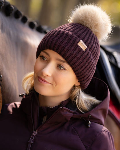Damson coloured LeMieux Clara Rib Beanie on blurry background 