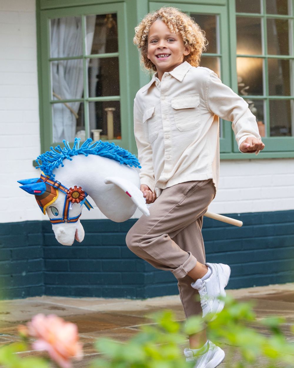 Pegasus coloured LeMieux Disney Hobby Horse Pegasus on house background 