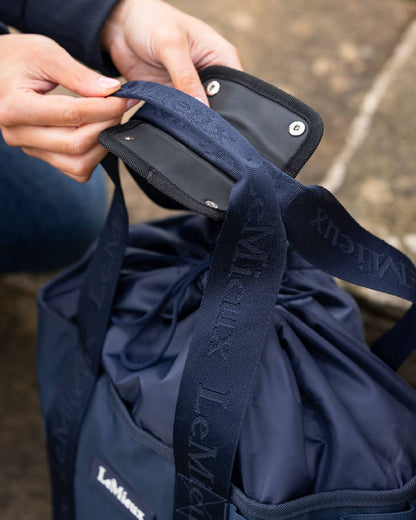 Navy coloured LeMieux Grooming Tote on blurry background 