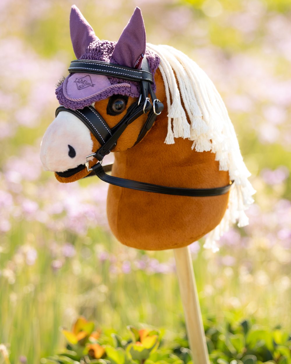 Sundance coloured LeMieux Hobby Horse Lite Sundance on garden background 