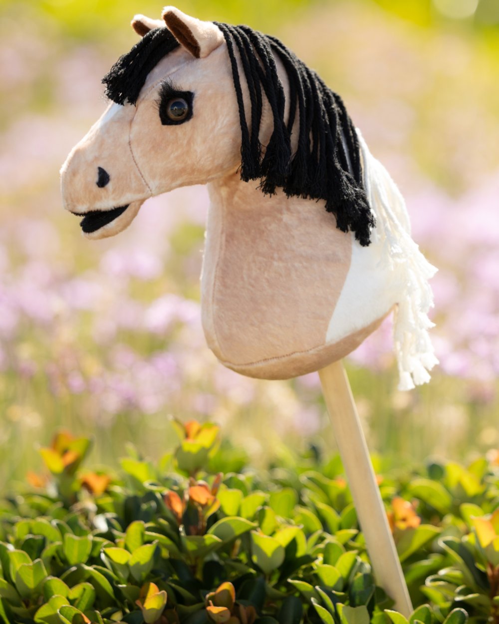 Toby coloured LeMieux Hobby Horse Lite Toby on garden background 