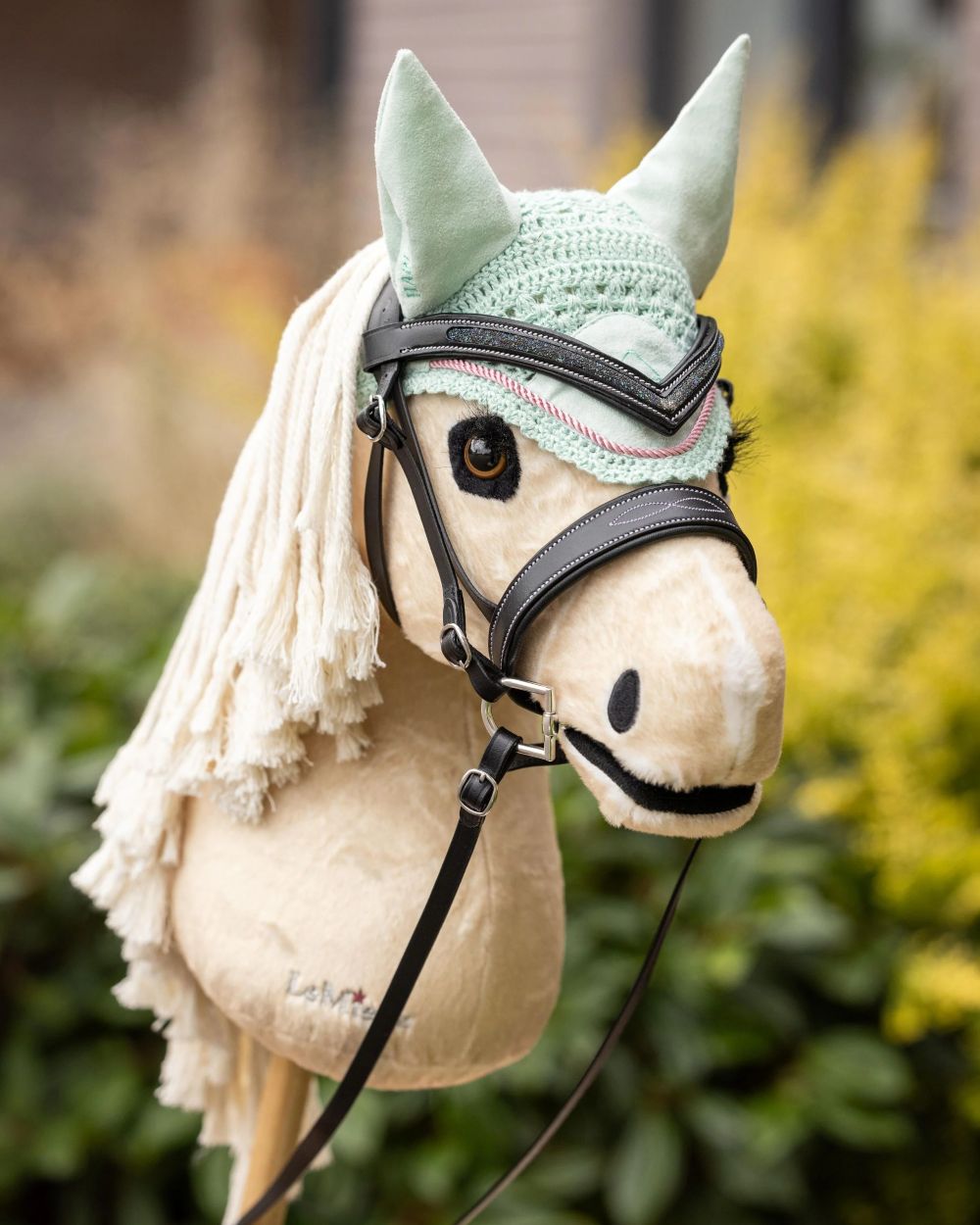 Popcorn coloured LeMieux Hobby Horse Popcorn on garden background 