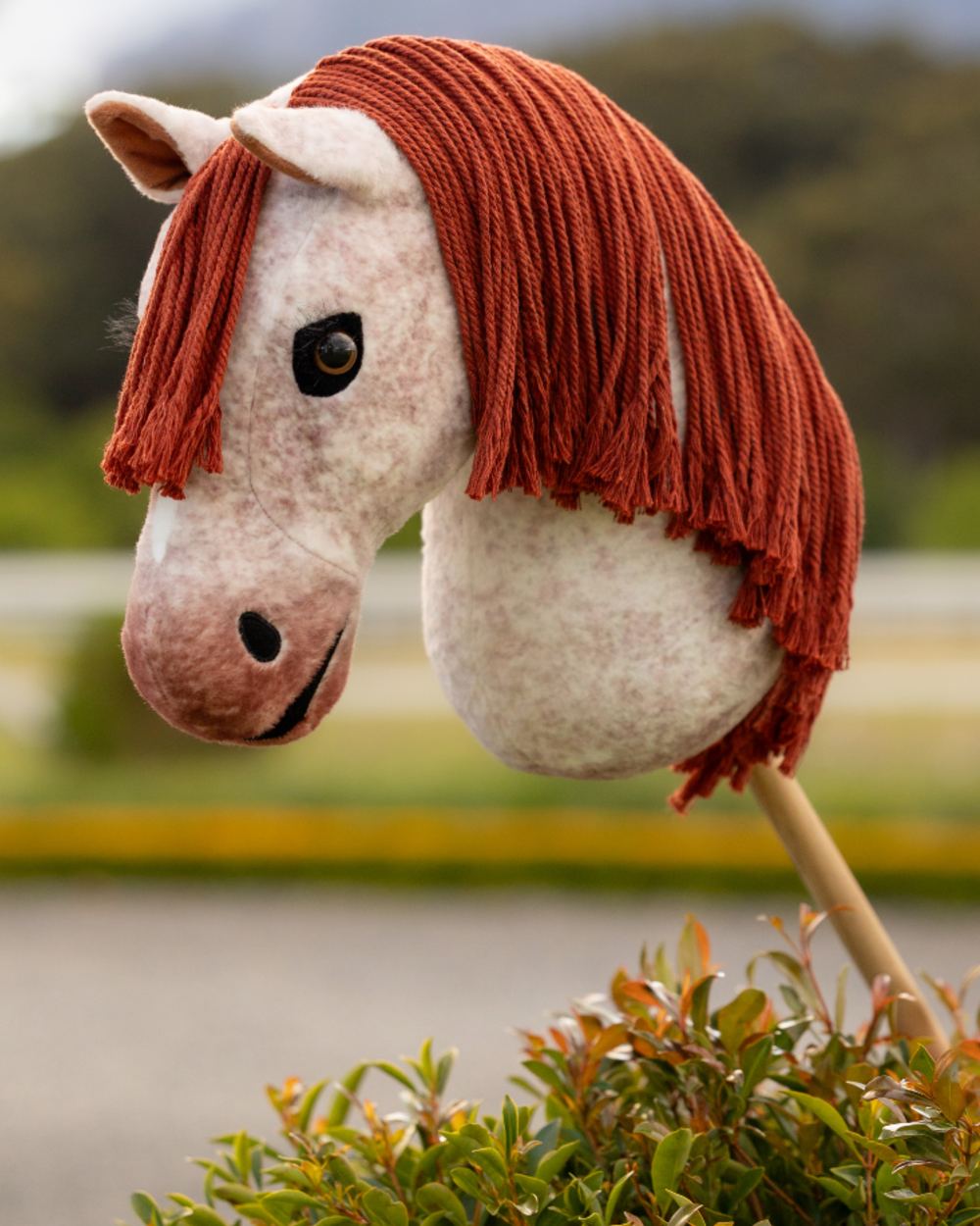 Poppy coloured LeMieux Hobby Horse Poppy on outdoor background 