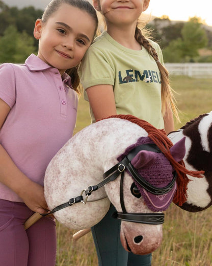 Poppy coloured LeMieux Hobby Horse Poppy on outdoor background 