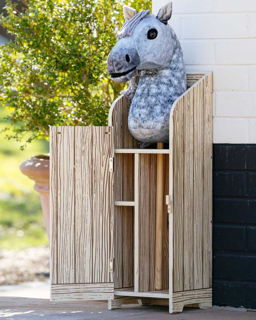 Wooden coloured LeMieux Hobby Horse Stable Wooden on outdoor background 