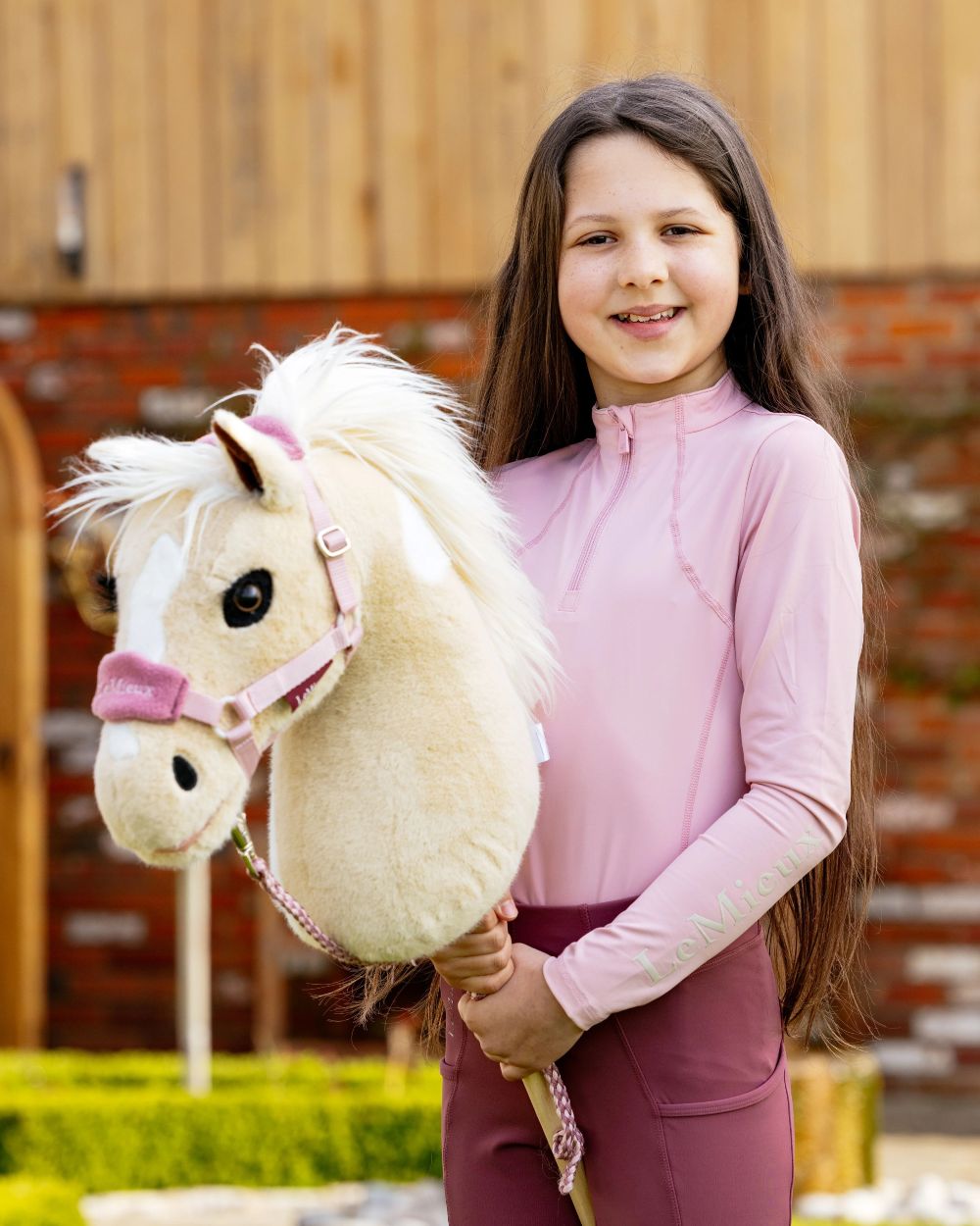 Blossom coloured LeMieux Hobby Horse Vogue Headcollar on wall background 