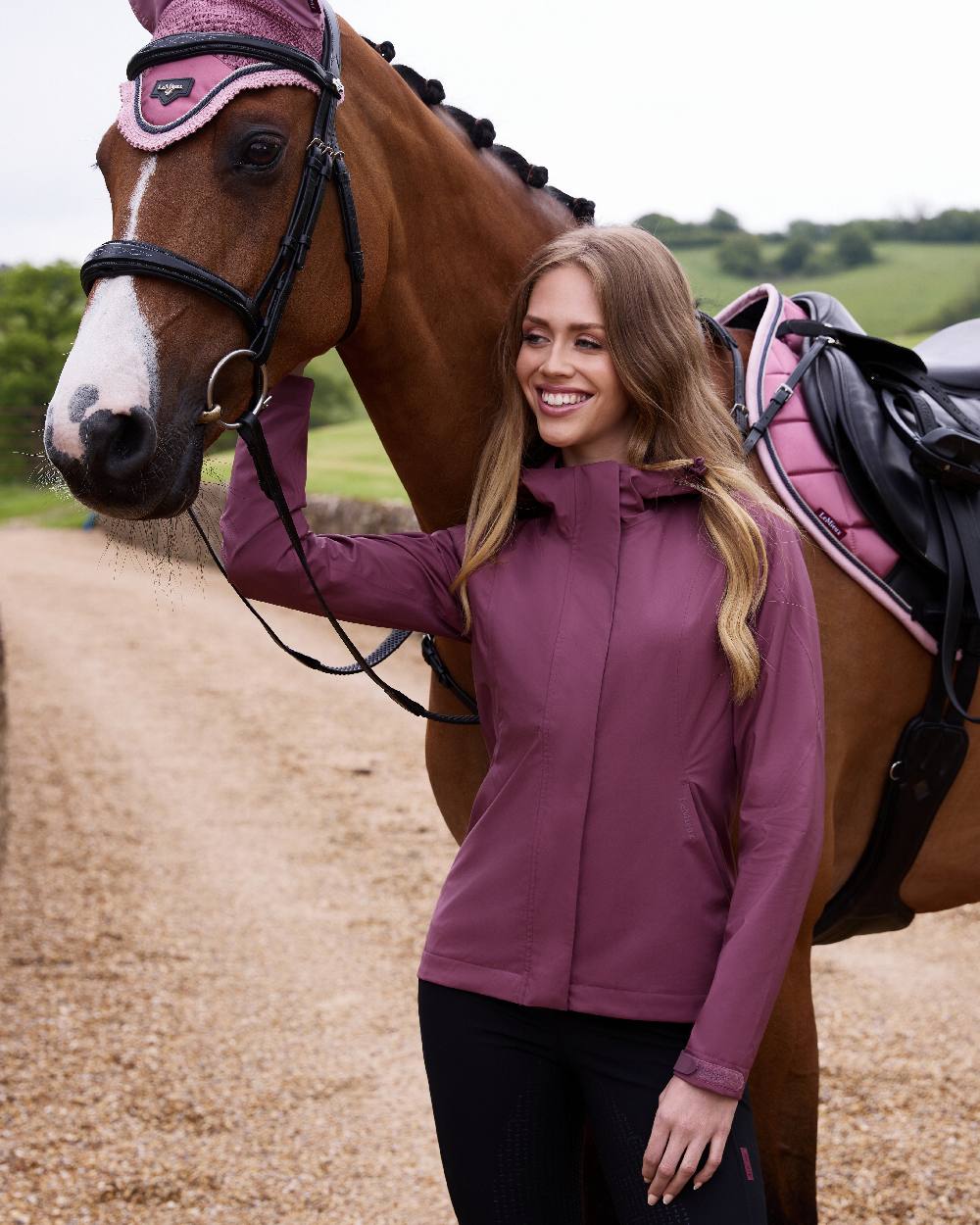 Rosewood coloured LeMieux Isla Short Waterproof Jacket on street background 