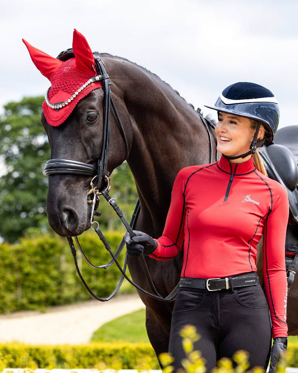 Chilli coloured LeMieux Loire Fly Hood on yard background 