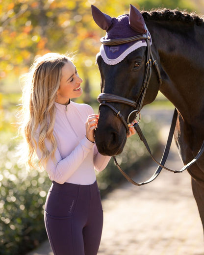 Juniper coloured LeMieux Loire Fly Hood on blurry background 
