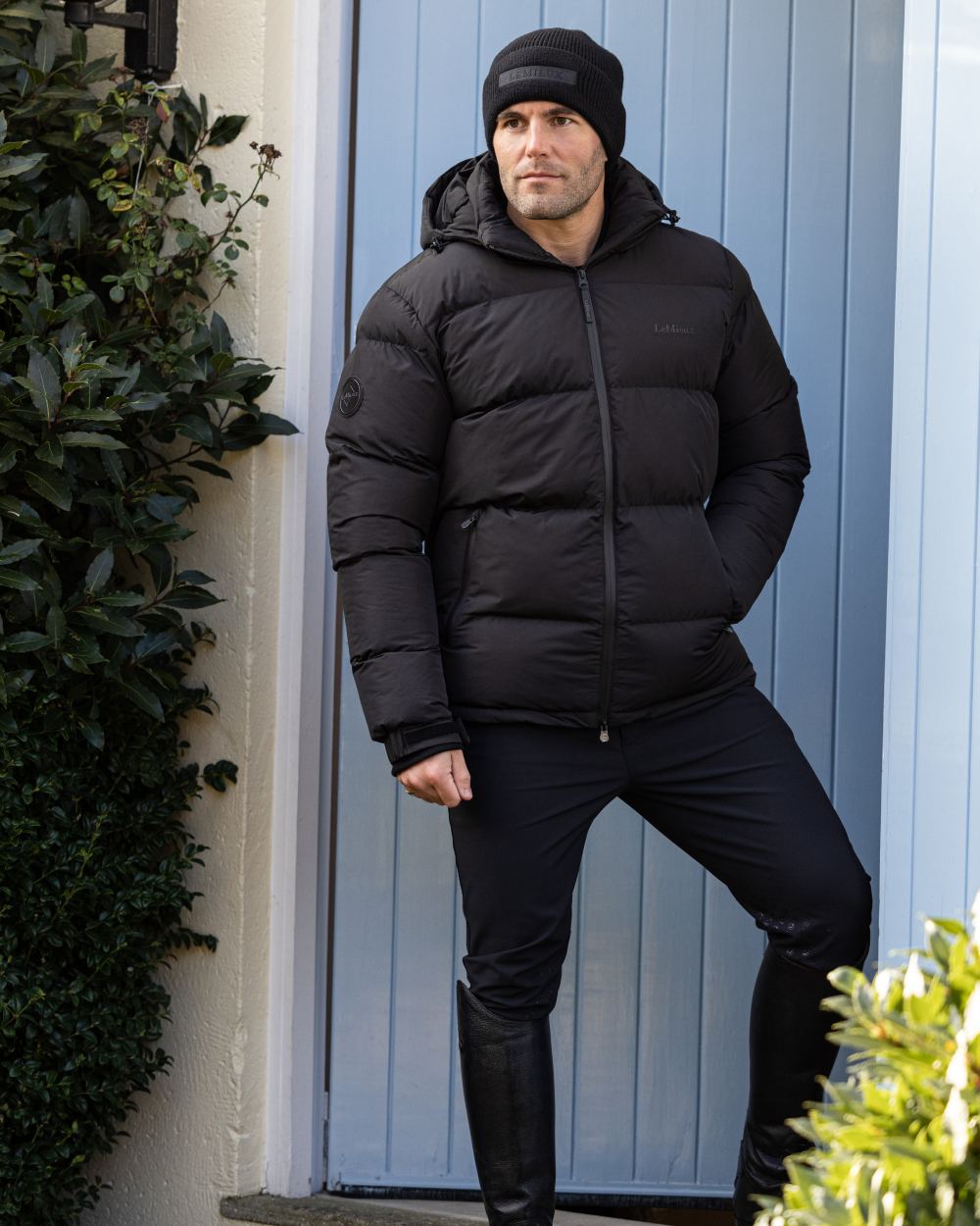 Black coloured LeMieux Mens Beanie on outdoor background 