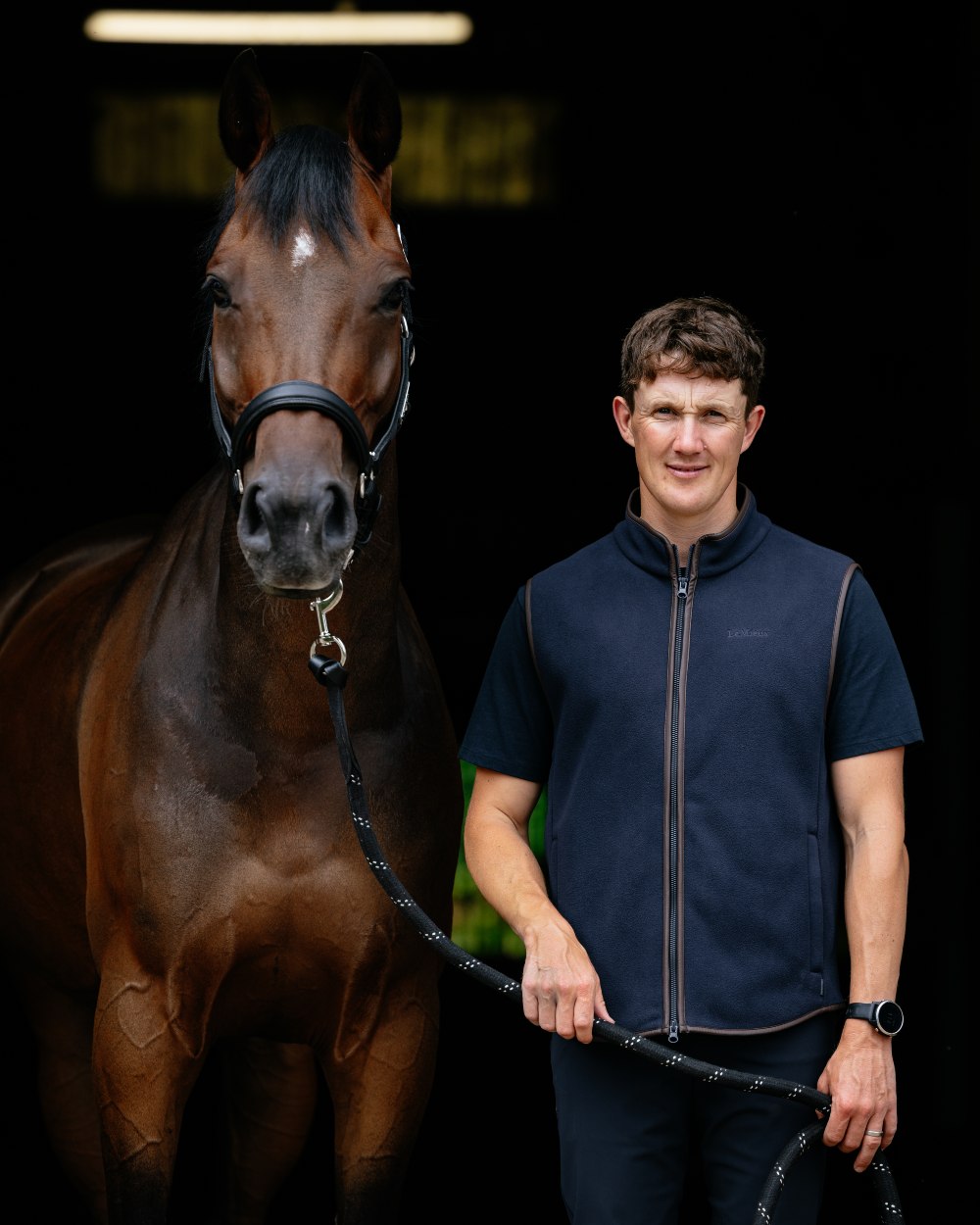 Navy Coloured LeMieux Mens Fleece Gilet on Outdoor with horse Background 
