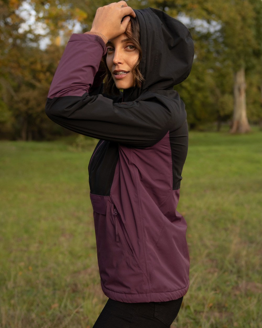 Black Bramble coloured LeMieux Phoebe Half Zip Waterproof Anorak on forest background 