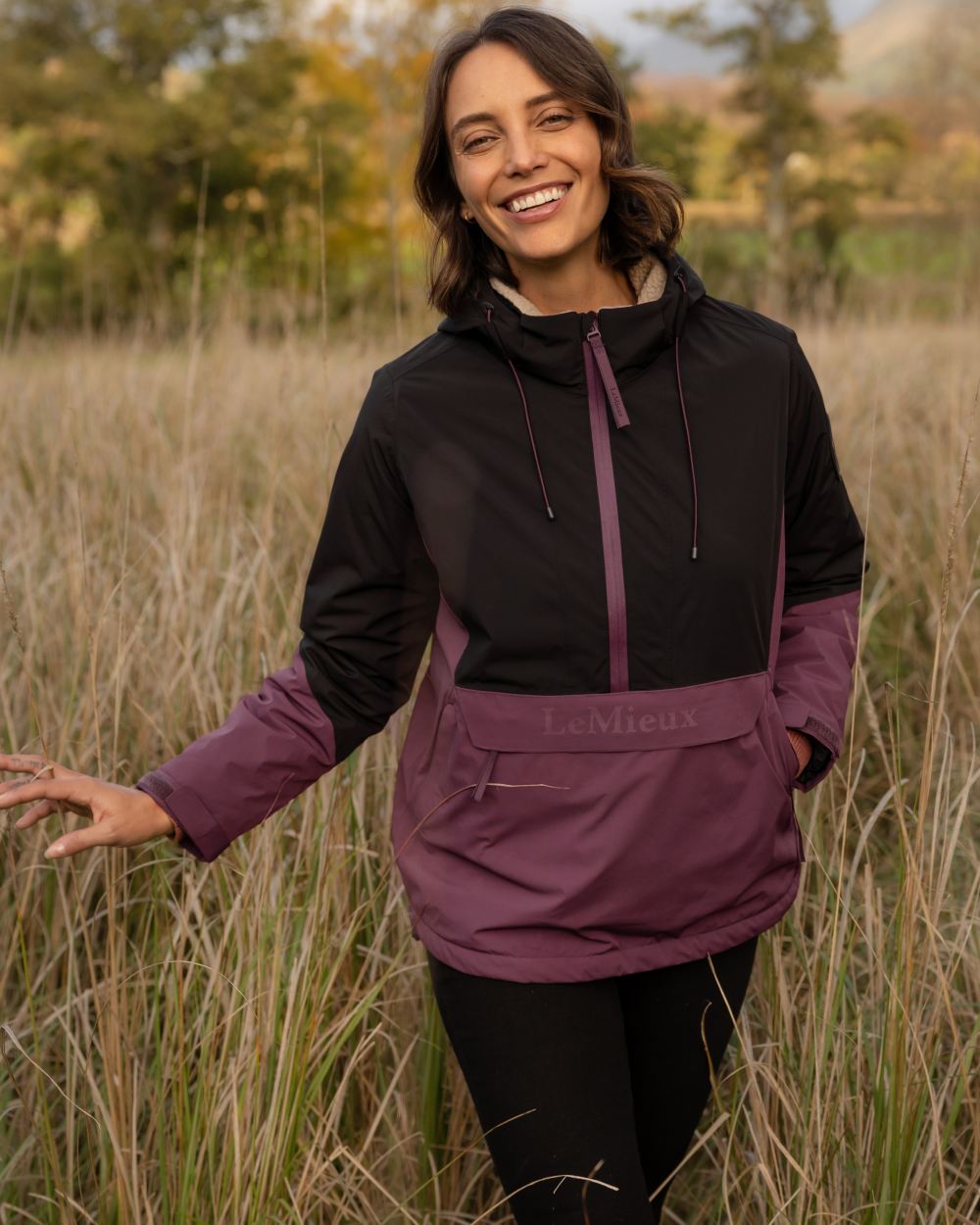 Black Bramble coloured LeMieux Phoebe Half Zip Waterproof Anorak on forest background 