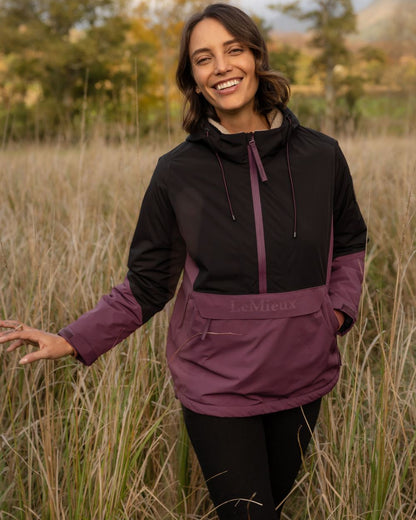 Black Bramble coloured LeMieux Phoebe Half Zip Waterproof Anorak on forest background 