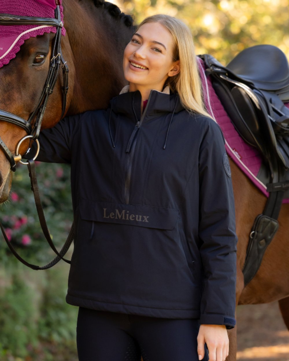 Navy coloured LeMieux Phoebe Half Zip Waterproof Anorak on outdoor background 