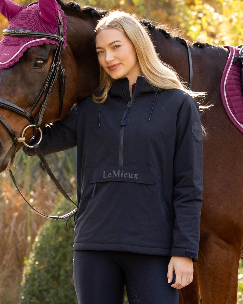 Navy coloured LeMieux Phoebe Half Zip Waterproof Anorak on outdoor background 